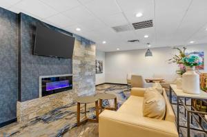 a waiting room with a couch and a fireplace at Best Western Plus Beckley Inn in Beckley