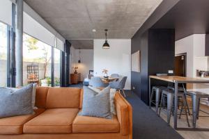a living room with a couch and a table at Knutsford Modern New Winter Warmer in Fremantle