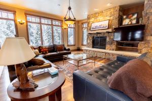 a living room with a couch and a fireplace at 671 Elk Circle by Summit County Mountain Retreats in Keystone
