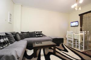 a living room with a couch and a table at Vila Oscar in Ksamil