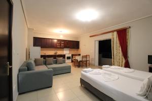 a living room with two beds and a couch at Vila Oscar in Ksamil