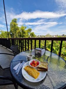 a table with a plate of food with toast and fruit at Coffee Tree Boutique Hostel in Salento