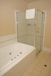 
a bathroom with a shower, sink, and tub at McCracken Country Club in Victor Harbor
