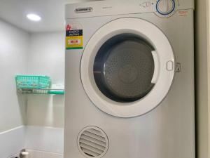 a white washing machine with its door open at Good Vibes Only on Stanley in Townsville