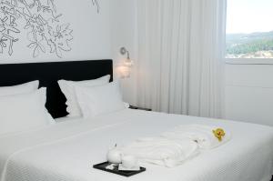 Cama ou camas em um quarto em Open Village Sports Hotel & Spa Club