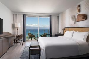 a hotel room with a bed and a view of the ocean at The Westin Maui Resort & Spa, Ka'anapali in Lahaina