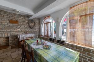 a dining room with two tables and two windows at Apartments by the sea Cove Zarace - Gdinj, Hvar - 2047 in Gdinj