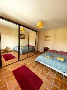 a bedroom with two beds and a large mirror at Maison accueillante à Gémozac - 100 m² avec jardin fertile. in Gémozac