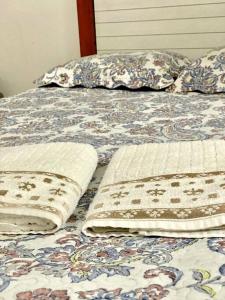 a bed with two pillows on top of it at Porto Allegra in Cabo Frio