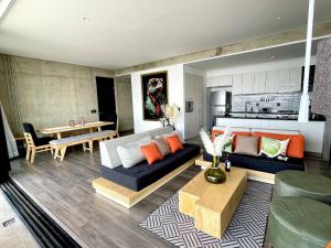a living room with a couch and a table at Espectacular diseño, terraza con Hamaca y Jacuzzi in Guadalajara