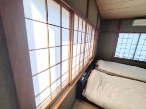 Postel nebo postele na pokoji v ubytování ビーチまで徒歩5分 BBQ無料 7名迄OK 戸建て貸切宿 Bignet villa