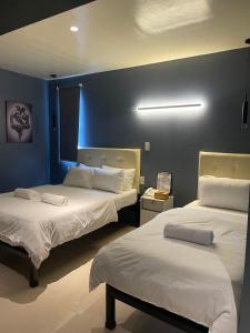 Postel nebo postele na pokoji v ubytování IAO Boutique Hotel