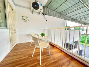 a balcony with a table and chairs and a speaker at Kampung8 17pax Snooker Arcade in Melaka