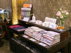 a display of clothes on a table in a store at Yufuin Besso Shikisai Hotel in Yufuin