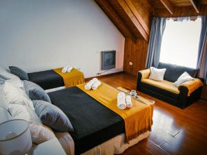 a hotel room with two beds and a couch at Constantino Hostel by lo de Guille in El Chalten +28 photos