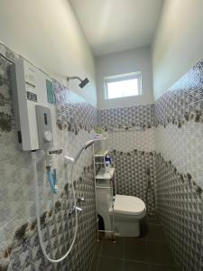 a bathroom with a shower and a toilet at Homestay Tok Ma 2 Gong Chempedak Marang in Marang +32 photos
