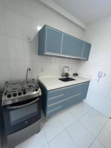a kitchen with a stove and a sink in it at SJC Funcional e Aconchegante in São José dos Campos +16 photos