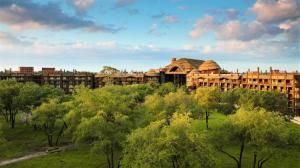 a large building with trees in front of it at Disney's Animal Kingdom Lodge in Orlando