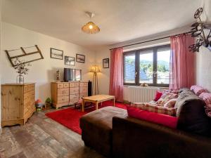 a living room with a couch and a window at Appartement 2 chambres, max 6 pers, proche des stations, centre-ville Cornimont - FR-1-589-666 in Cornimont