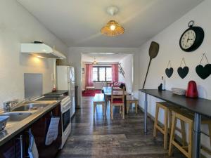 a kitchen with a counter and a dining room at Appartement 2 chambres, max 6 pers, proche des stations, centre-ville Cornimont - FR-1-589-666 in Cornimont