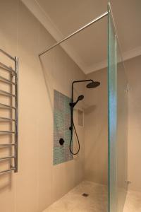 a shower with a glass enclosure in a bathroom at Family Camping Paradise with Kangaroos and Nature in Greta