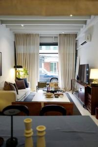 a living room with a couch and a table at Nap by Snooze in Bangkok