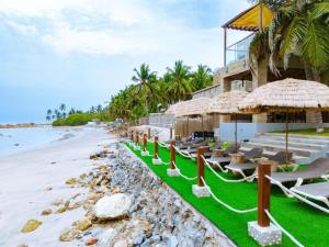 a resort on the beach with lounge chairs at B1 Serenity Terraces, Beach Hotel- Kokrobite in Kokrobite