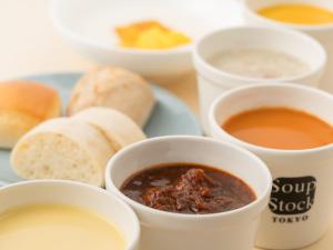 a plate of food with bowls of soup and bread at Hotel Villa Fontaine Tokyo-Hamamatsucho in Tokyo