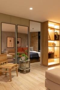 a living room with a bedroom and a bed at Forever W&L Apartments in El Poblado