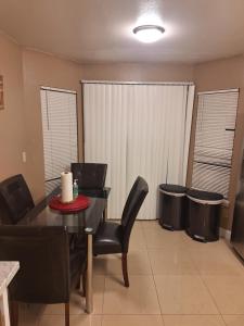 a dining room with a table and chairs and trash cans at Mozzy-Love Room in Orlando +45 photos