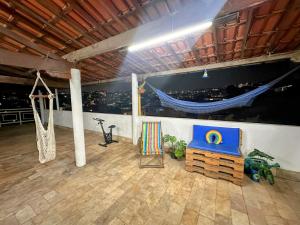 a room with a large painting of a boat on the wall at Suite casal com frigobar in Belo Horizonte