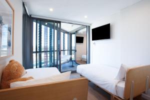 a living room with a teddy bear sitting on a couch at Modern Splendour, Macquarie Park I90 in Sydney +21 photos