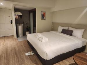 Postel nebo postele na pokoji v ubytování Gecko EYE Hotel