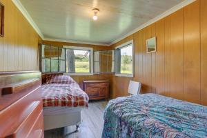 a bedroom with a bed and a dresser and windows at Honesdale Cabin 110 Shared Acres, Animal Rescue! in Honesdale