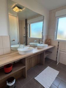 a bathroom with three sinks and a large mirror at Le Phare in Agon Coutainville +7 photos