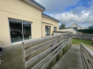 a wooden fence in front of a house at Le Phare in Agon Coutainville