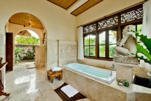 a bathroom with a tub and a statue of a woman at Fullara 1 BR Suite With Rice Field View ZN240 in Ubud +19 photos