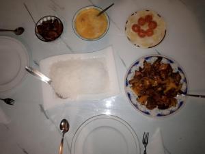 a table with a plate of food and a bowl of cereal at The bawa guest Inn in Haputale