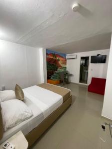 Postel nebo postele na pokoji v ubytování Hotel Hernández CTG