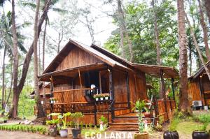 a small wooden house in the middle of a forest at Eco Lanta Hideaway Beach Resort in Ko Lanta