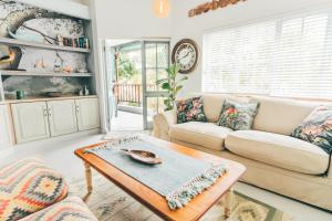 a living room with a couch and a table at The Kingfisher in Plettenberg Bay