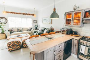 a kitchen and living room with a couch at The Kingfisher in Plettenberg Bay +37 photos