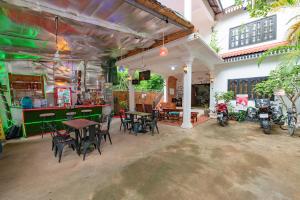 a restaurant with tables and chairs and motorcycles in it at NAMO ANGKOR VILLa in Siem Reap