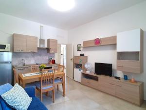 a kitchen with a table and a dining room at Charming Apartment near Lake Maggiore in Luino +32 photos
