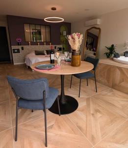 a room with a table and chairs and a bed at Les Suites du Payré - Suite Passion in Talmont +28 photos