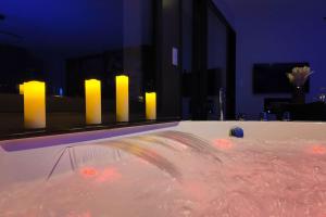 a bath tub filled with lots of water with lights at Les Suites du Payré - Suite Passion in Talmont