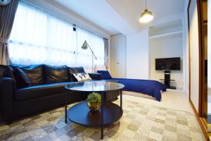 a living room with a couch and a table at Hostel Inn Tokyo Ryogoku in Tokyo