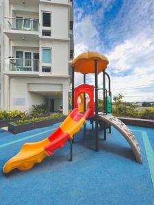 une aire de jeux avec toboggan en face d'un bâtiment dans l'établissement 19 Cityscape Views, à Cari Mayor