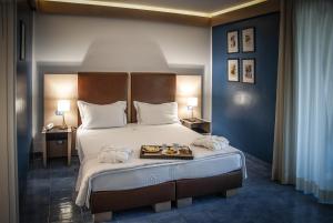 ein Schlafzimmer mit einem Bett, auf dem ein Tablett mit Essen steht in der Unterkunft Hotel Fontermosa in Fonteblanda + 52 Fotos