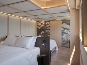 Postel nebo postele na pokoji v ubytování Reddot Hotel